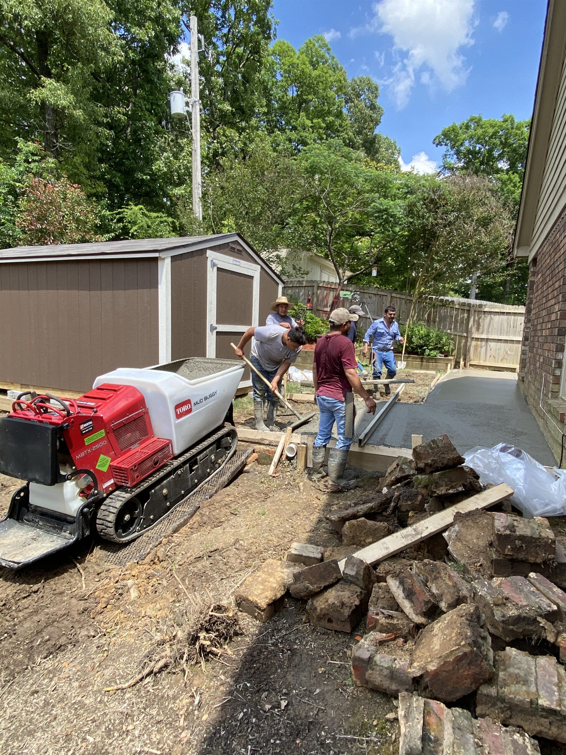 Instant Projects crew pouring a concrete walkway beside a Memphis-area home